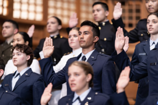 ROTC Cadets and Midshipmen raise their right hands as they take their oath