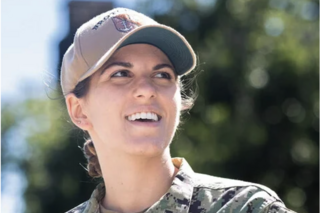 NROTC Midshipman smiles at something off-camera. 
